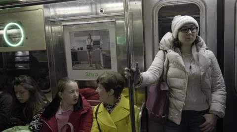 Panning across interior of subway train car passengers sitting talking 4K NYC Stock Footage 58757518