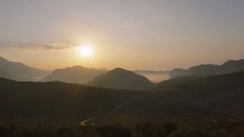 Panning Across Landscape of Picos De Europa with Sun Dimmed by Partial Eclipse. Stock Footage 346593091