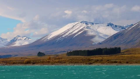 Panning Across Snow-Capped Mountains and Lake Tekapo Shoreline 動画素材 314029449