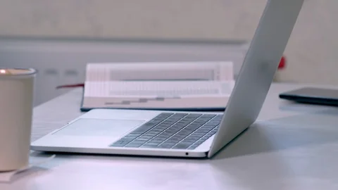 Panning across a workstation in the office Stock Footage 125898343