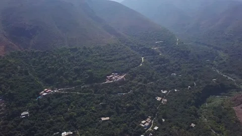 Panning aerial drone view of mountains and green trees of the highlands of Cumbe Stock Footage 198796397