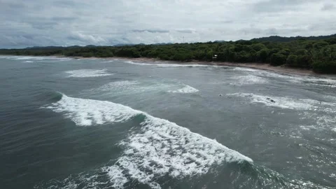 Panning aerial of ocean waves on empty beach Stock Footage 213714305