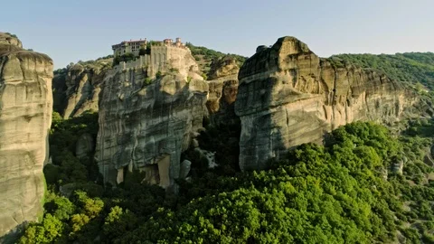 Panning aerial shot complex of monasteries on the peak of rock Meteora in Greece Stock Footage 97645568