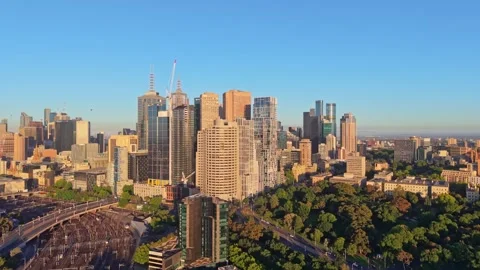Panning aerial view of Melbourne CBD skyscrapers at golden hour Stock Footage 325461918