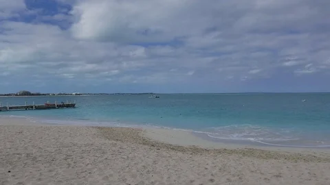 Panning along beach during a cloudy day in Grace Bay, Providenciales, Turks and Stock Footage 91116146