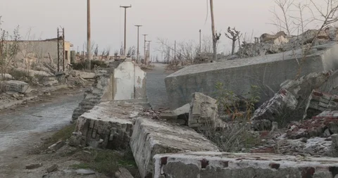 Panning along constructions rubble and ruins at destroyed and abandoned city 스톡 동영상 126311278
