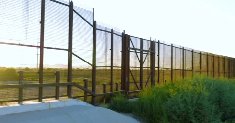 Panning Along the Fence and River Dividing Countries Stock Footage