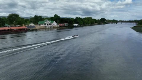 Panning and chasing a long tail boat on the river. Video stock 248828549