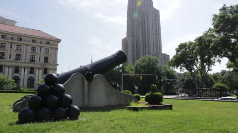 Panning up and down from the Cathedral of Learning to a cannon in Pittsburgh Stock Footage 64894811