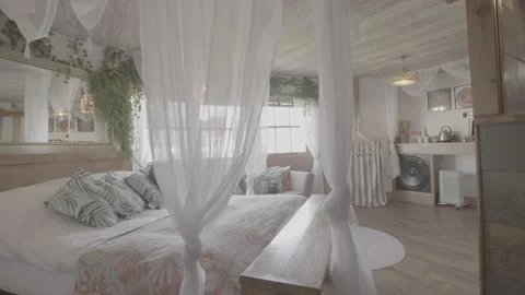 Panning and tracking shot of open bedroom, nature, chic room Stock Footage 202132582