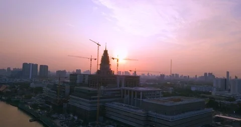 Panning around cranes at building construction on a river in Bangkok Video stock 108573636