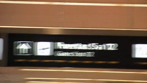 Panning back and forth across airport sign showing toilets gates  exit and no Video stock 95605711