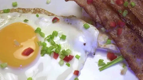 Panning from bacons to egg on white backdrop. Video stock 131973755