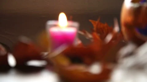 Panning from blurred candle to focused pumpkin Stock-Footage 55845649