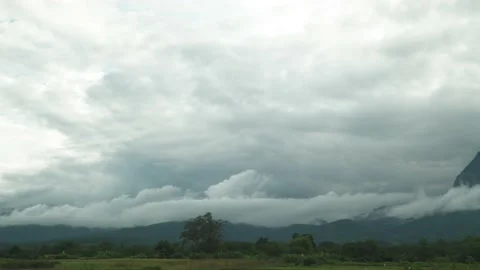 Panning camera The blue sky replace to overcast dark sky covered mountain Stock Footage 198799419