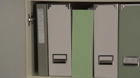 Panning camera on office cupboard. Files in office cupboard. Stock Footage 60812208