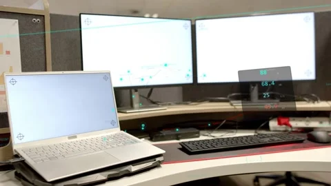 Panning camera showing silver laptop on raised stand at cubicle, revealing HUD Stock Footage 332820837