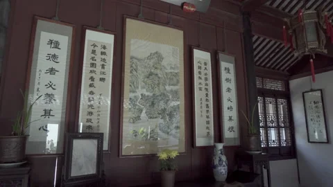 Panning: Chinese script with painting frames hanging on wall - Suzhou, China Stock Footage 149671818