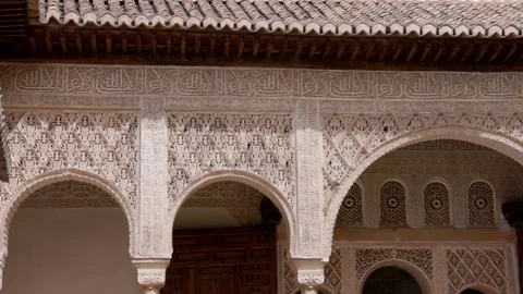 Panning clip of arabic script on a wall of the ancient palace-fortress alhambra Stock Footage 249732525