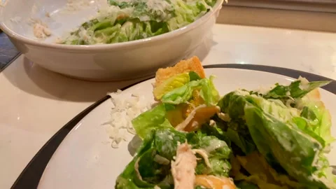 Panning Close Up Of Chicken Caesar Salad In Restruant Overlooking Kitchen Stock Footage 219694627