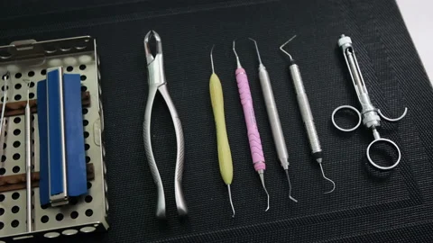 Panning close-up shot of Dentist tools on black mat. Dental health concept Stock Footage 131483908