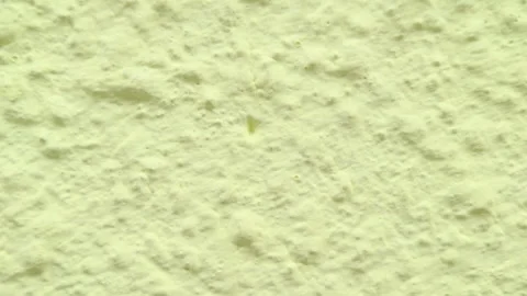 Panning Close Up Shot of Pale Yellow Painted Plaster Wall Surface Texture Stock Footage 336785190