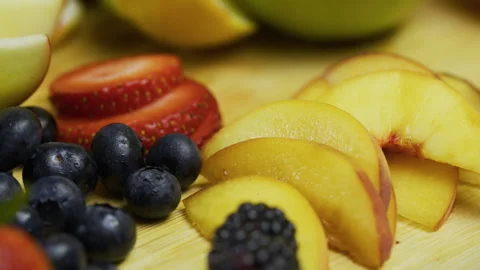 Panning closeup shot across fresh sliced and whole fruit on counter Stock Footage 341270697