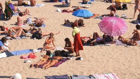 Panning up of Crowded sandy beach in Cascais near Lisbon, Portugal during the Stock Footage 114742591