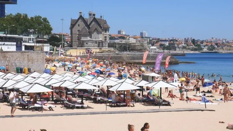 Panning of crowded sandy Conceicao beach in Cascais near Lisbon, Portugal during Stock Footage 112886721