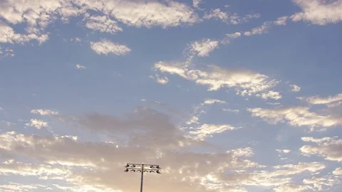 Panning down from clouds to the top of a stadium Stock Footage 103867065