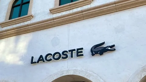 Panning down on the Lacoste retail store sign at a mall in Orlando, Florida. Stock Footage 160673926