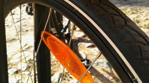 Panning down the length of the front wheel of a black bicycle Stock Footage 107567936