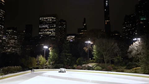 Panning down from NYC Skyline to Central Park Ice skating rink Stock Footage 200792720