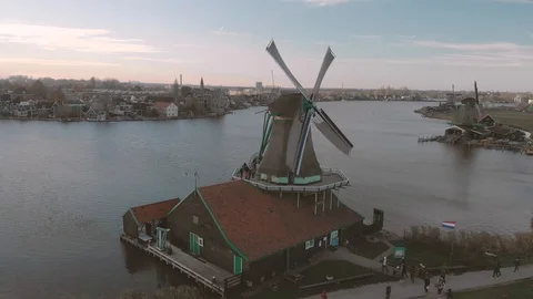 Panning down on a picturesque view of a windmill in the foreground on a Stock Footage 99318177