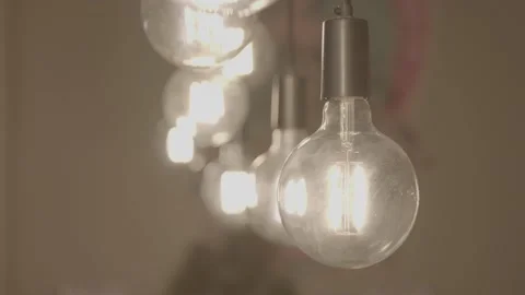 Panning down shot of hanging light bulbs Stock Footage 198341929