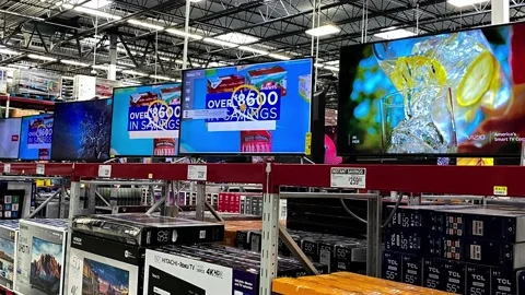 Panning down on the TV aisle of a Sams Club Wholesale retail store with a var Stock Footage 157012016
