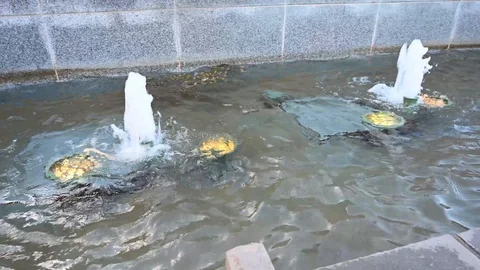 Panning down a water fountain with multiple sprouts of water coming up. Stock Footage 121406330