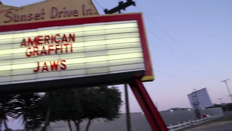 Panning from drive in marquee to kid staring at it Stock Footage 150383864