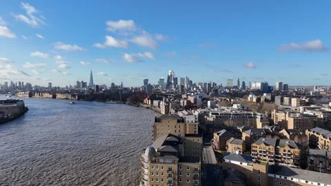 Panning drone aerial Wapping over River Thames city skyline in background Stock Footage 297660835