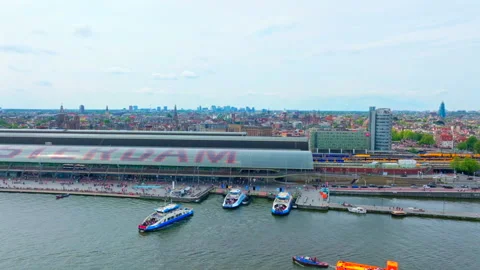 Panning Drone Shot Amsterdam Central Station and IJ Ferries 4K Netherlands Stock Footage 334539924