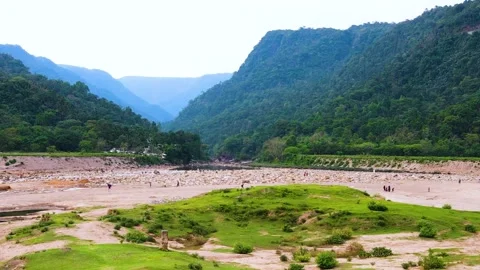 Panning drone shot of a dry river bed and Khasi hills near the Bangladeshi and Stock Footage 345276251