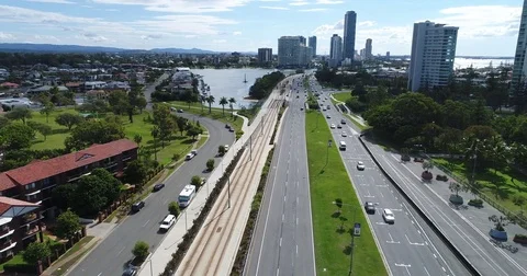 Panning drone view of moving traffic reveling beach background  Stock Footage 76105158
