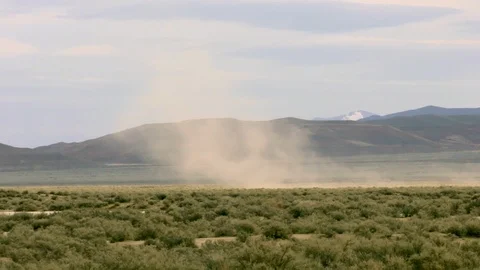 Panning with Dust Devil blowing across planes in Nevada in front of Video stock 95749919