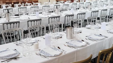 Panning footage of an empty,  set, long, formal dinning table Stock Footage 318518430