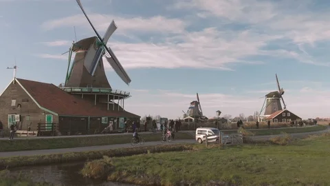 Panning up from ground level showing a windmill in a typical Dutch Stock Footage 99328959