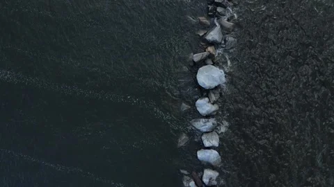A Panning High Angle View of A Column Of Rocks In A River Stock Footage 161677523