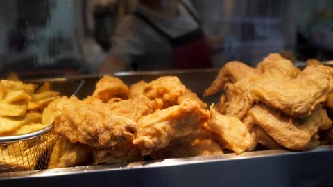 Panning of hot fried chicken on display Stock Footage 99335918