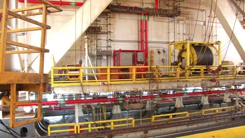 Panning of an industrial structure of cables, heavy machines, pipes and Stock Footage 103542609