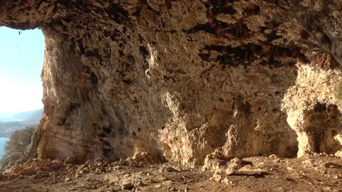 Panning inside of ancient cave opening and viewing Kas coastline 스톡 동영상 343161109