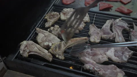 Panning lamb chops cooking with flames on a barbecue. Life style. Stock Footage 163653419